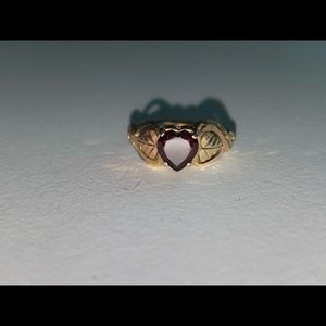 Gold ring with red heart